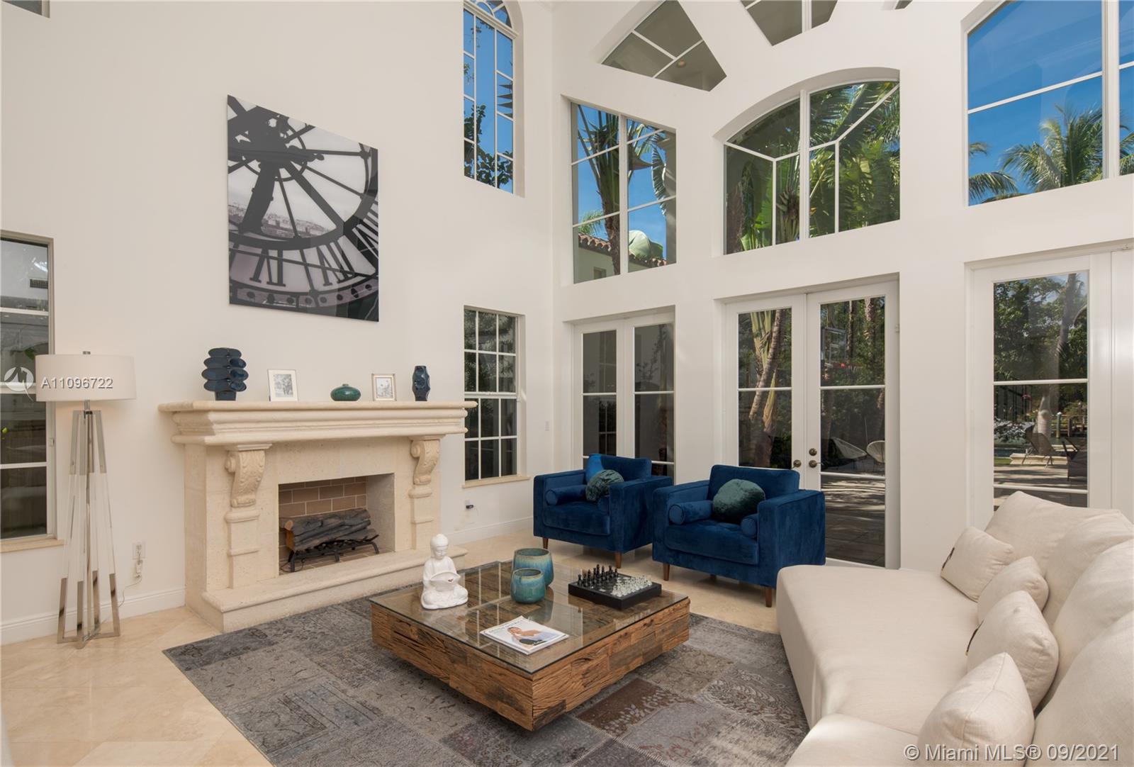 4900 Pine Tree Drive Miami Beach, FL 33140 - Photo 17 of 64 a living room with furniture a rug and a fireplace