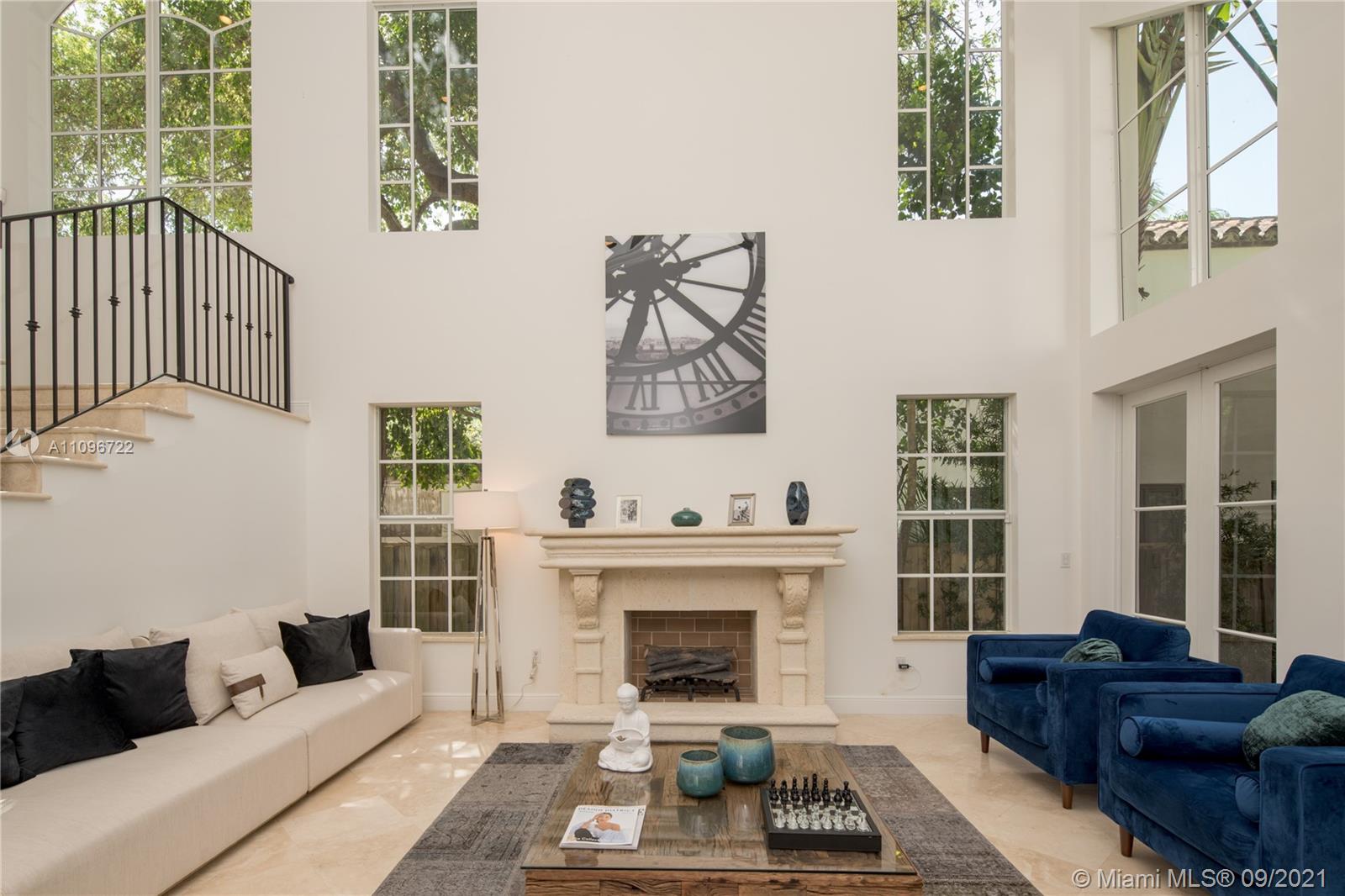 4900 Pine Tree Drive Miami Beach, FL 33140 - Photo 18 of 64 a living room with furniture and a fireplace