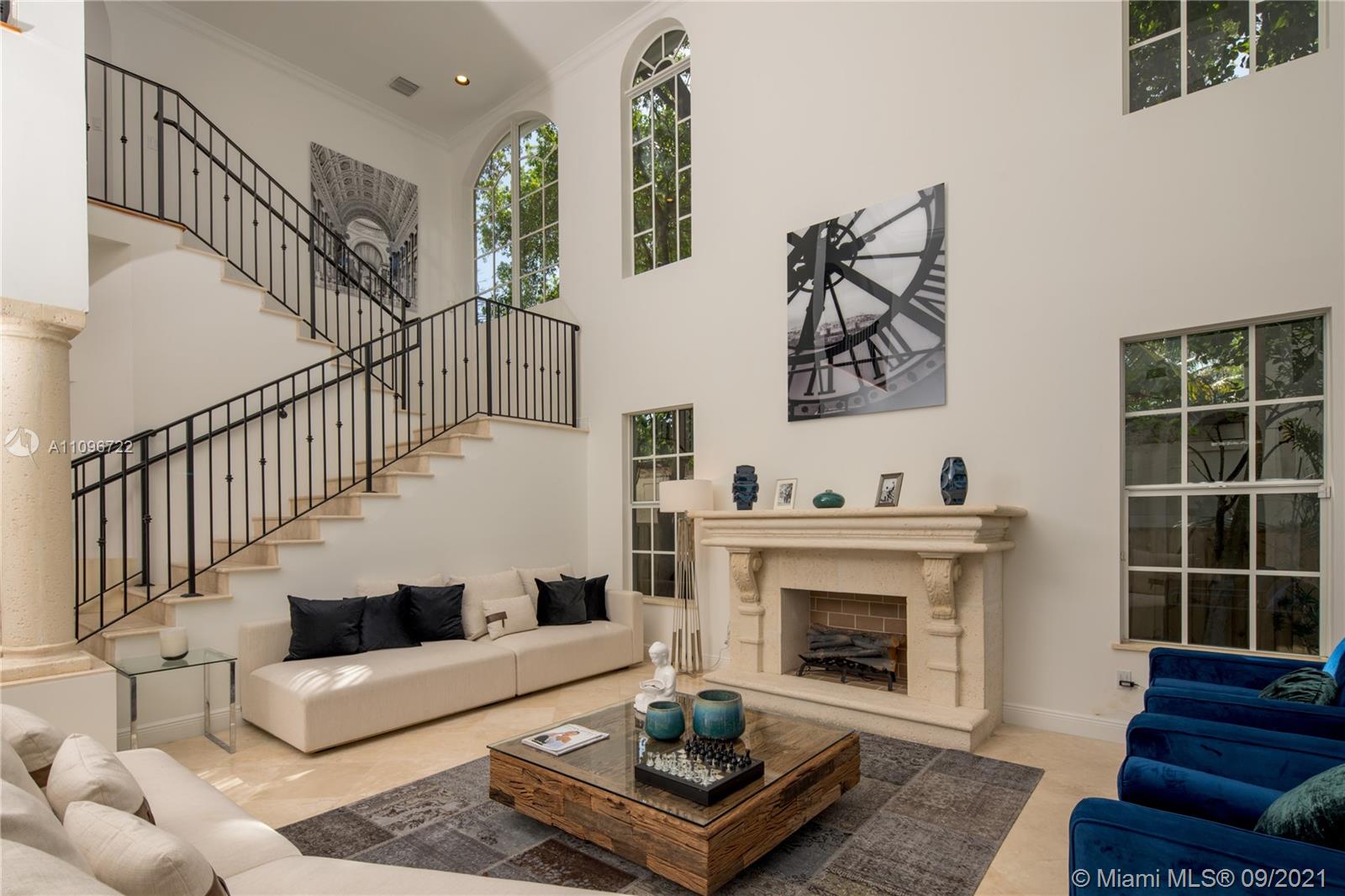 4900 Pine Tree Drive Miami Beach, FL 33140 - Photo 19 of 64 a living room with furniture and a fireplace