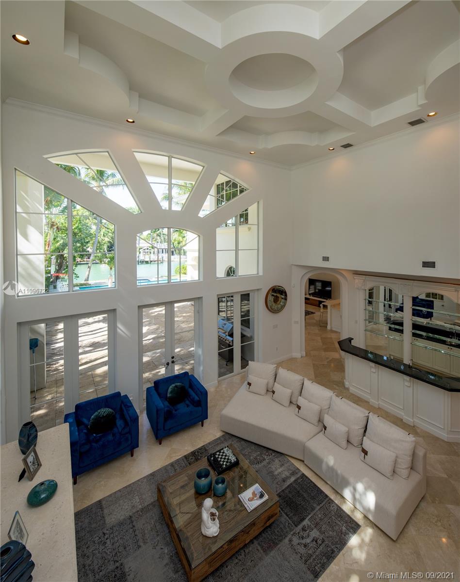 4900 Pine Tree Drive Miami Beach, FL 33140 - Photo 23 of 64 a living room with furniture and a large window