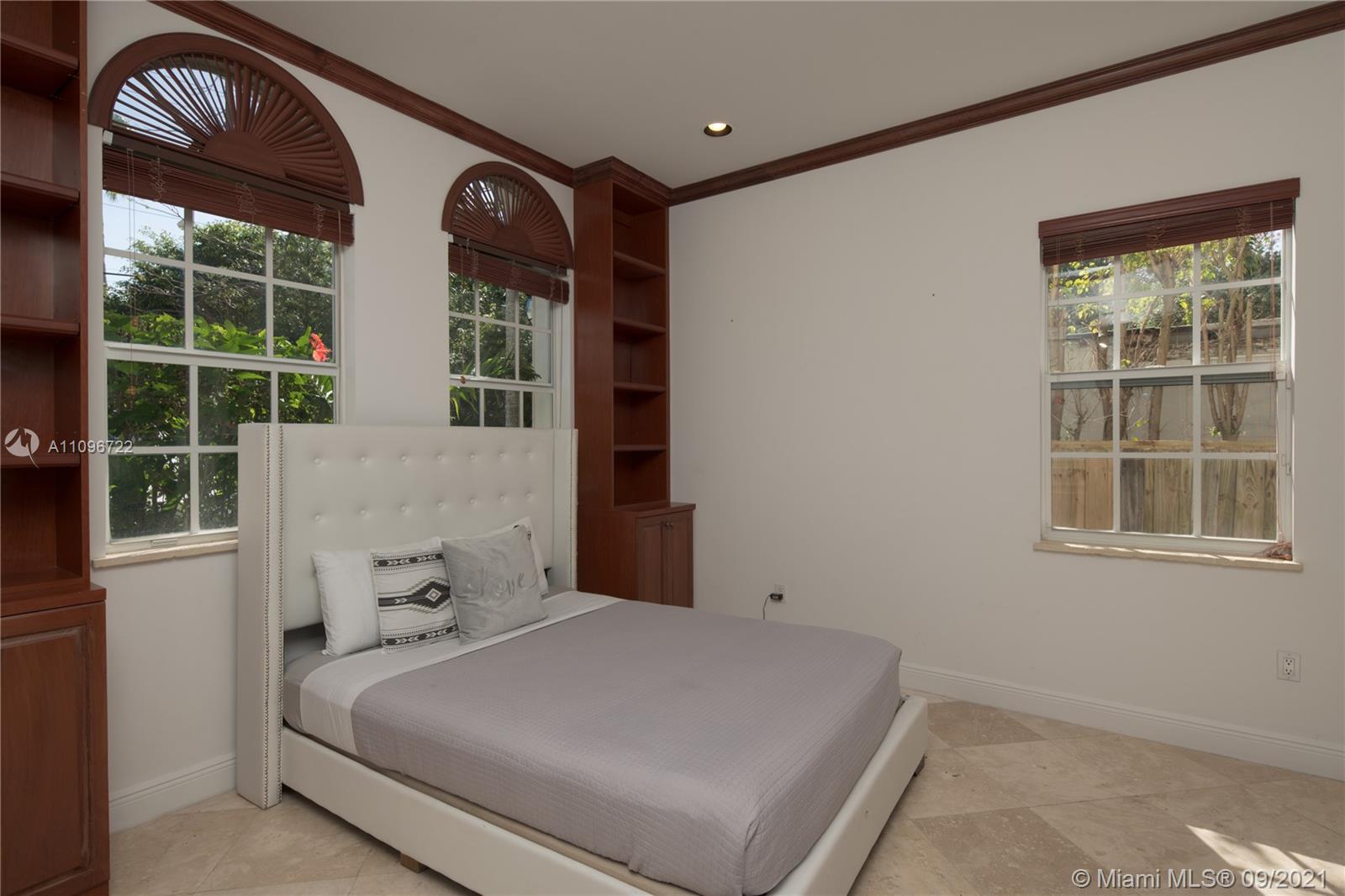 4900 Pine Tree Drive Miami Beach, FL 33140 - Photo 27 of 64 a bedroom with a bed and a window