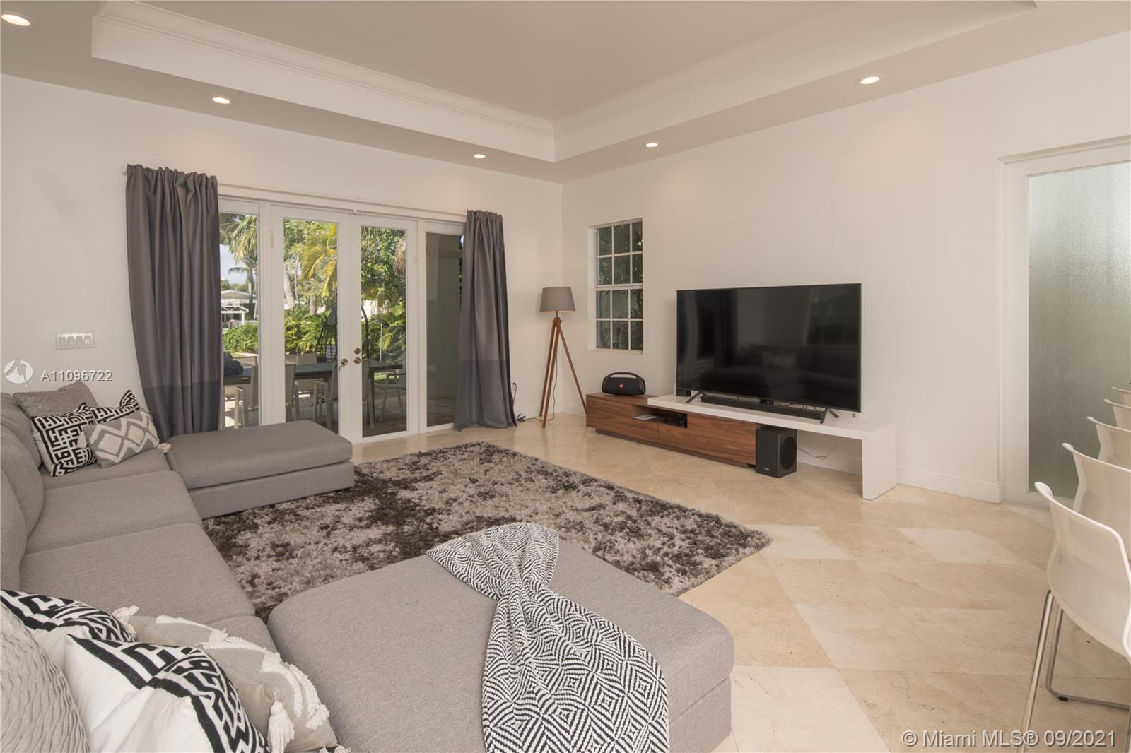 4900 Pine Tree Drive Miami Beach, FL 33140 - Photo 32 of 64 a bedroom with a bed and a flat screen tv