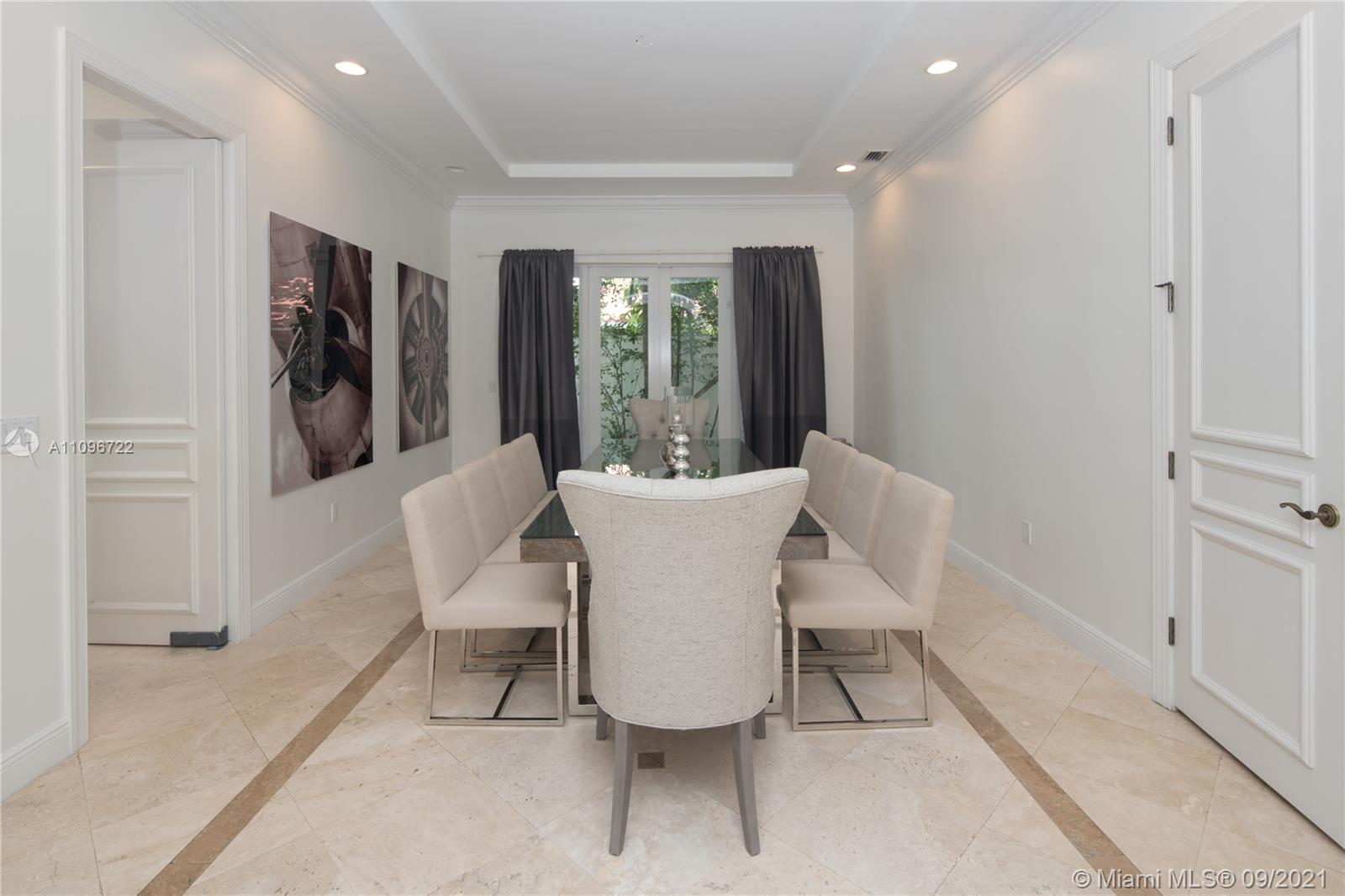 4900 Pine Tree Drive Miami Beach, FL 33140 - Photo 35 of 64 a view of a dining room with furniture and window