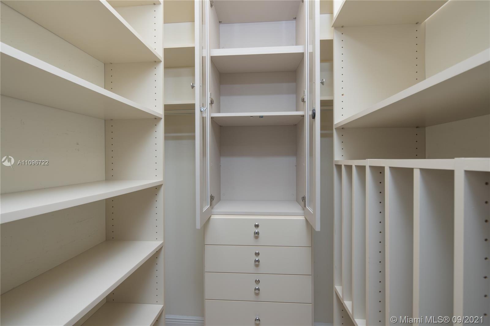 4900 Pine Tree Drive Miami Beach, FL 33140 - Photo 36 of 64 a view of an empty walk in closet
