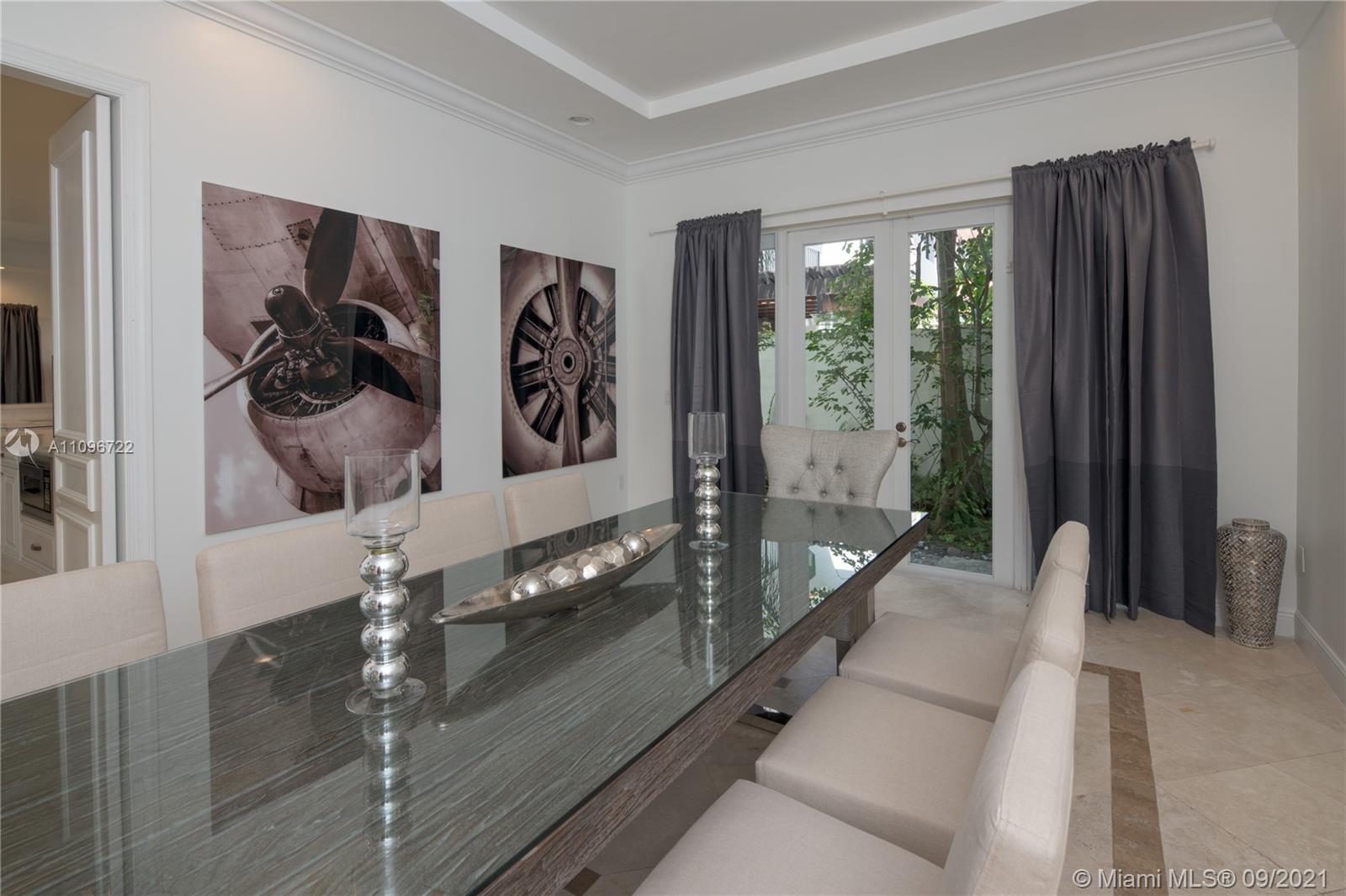 4900 Pine Tree Drive Miami Beach, FL 33140 - Photo 37 of 64 a hallway with a large window