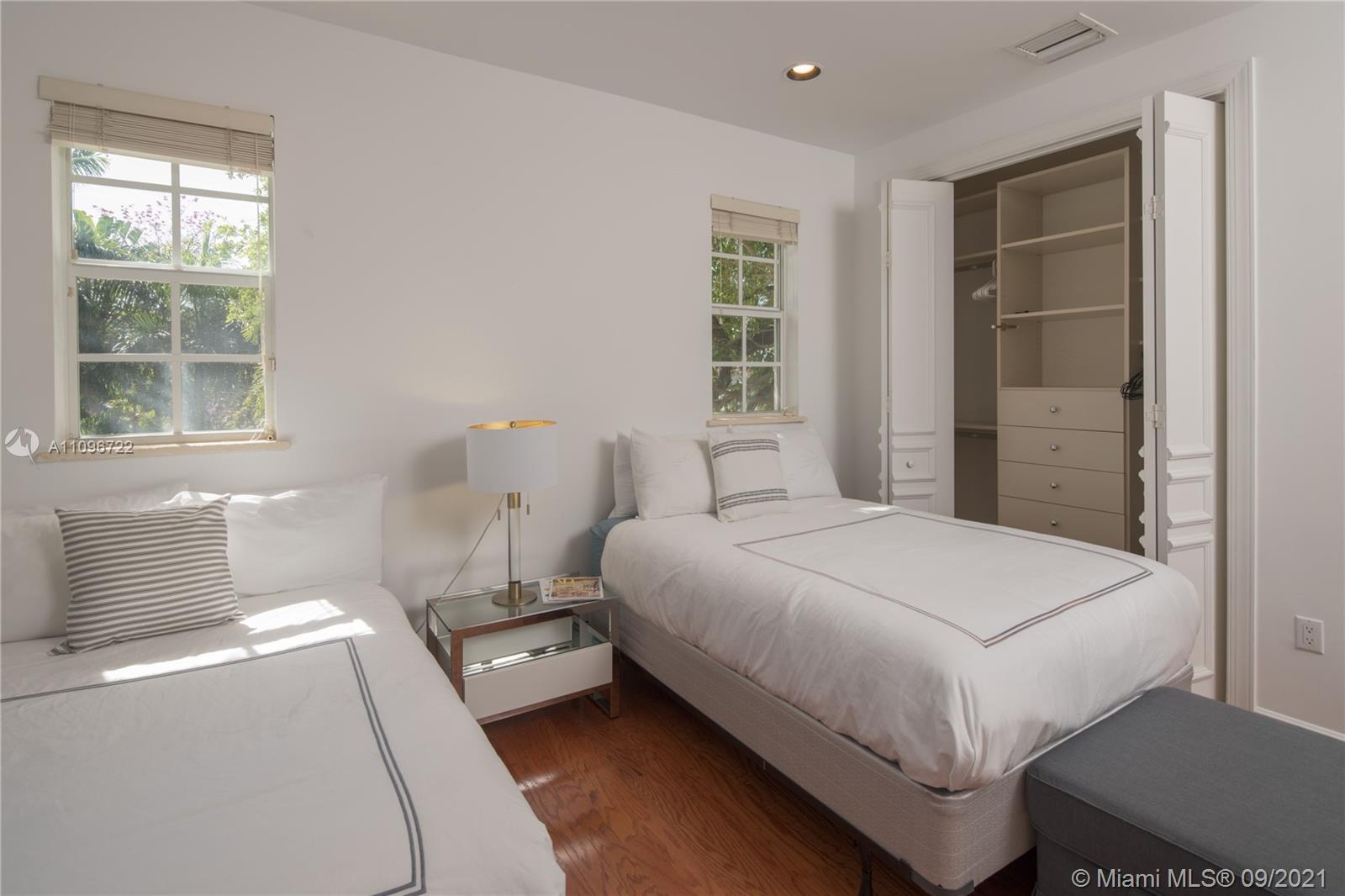 4900 Pine Tree Drive Miami Beach, FL 33140 - Photo 40 of 64 a bedroom with a bed and a window