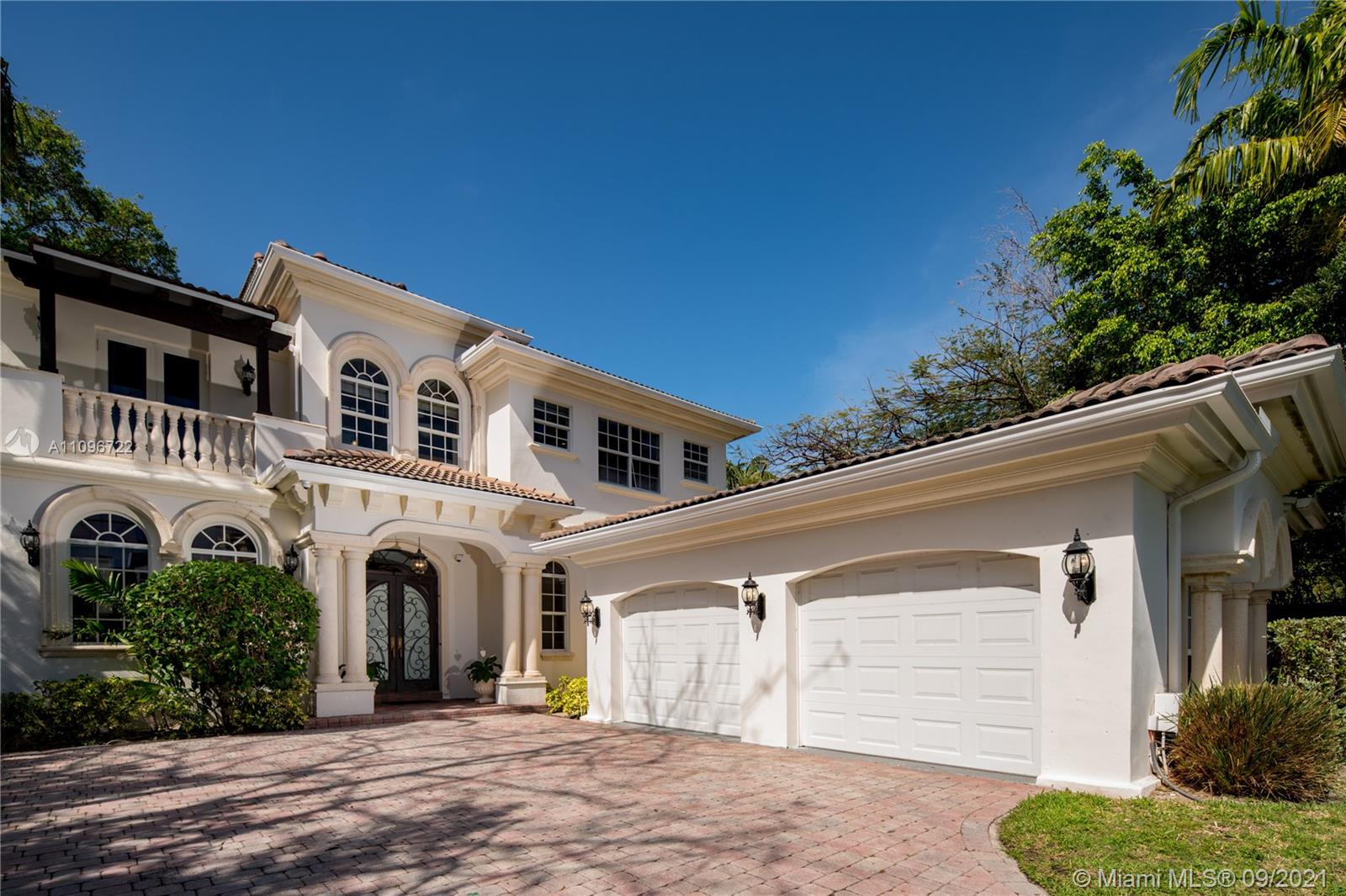 4900 Pine Tree Drive Miami Beach, FL 33140 - Photo 5 of 64 a front view of a house with a garage