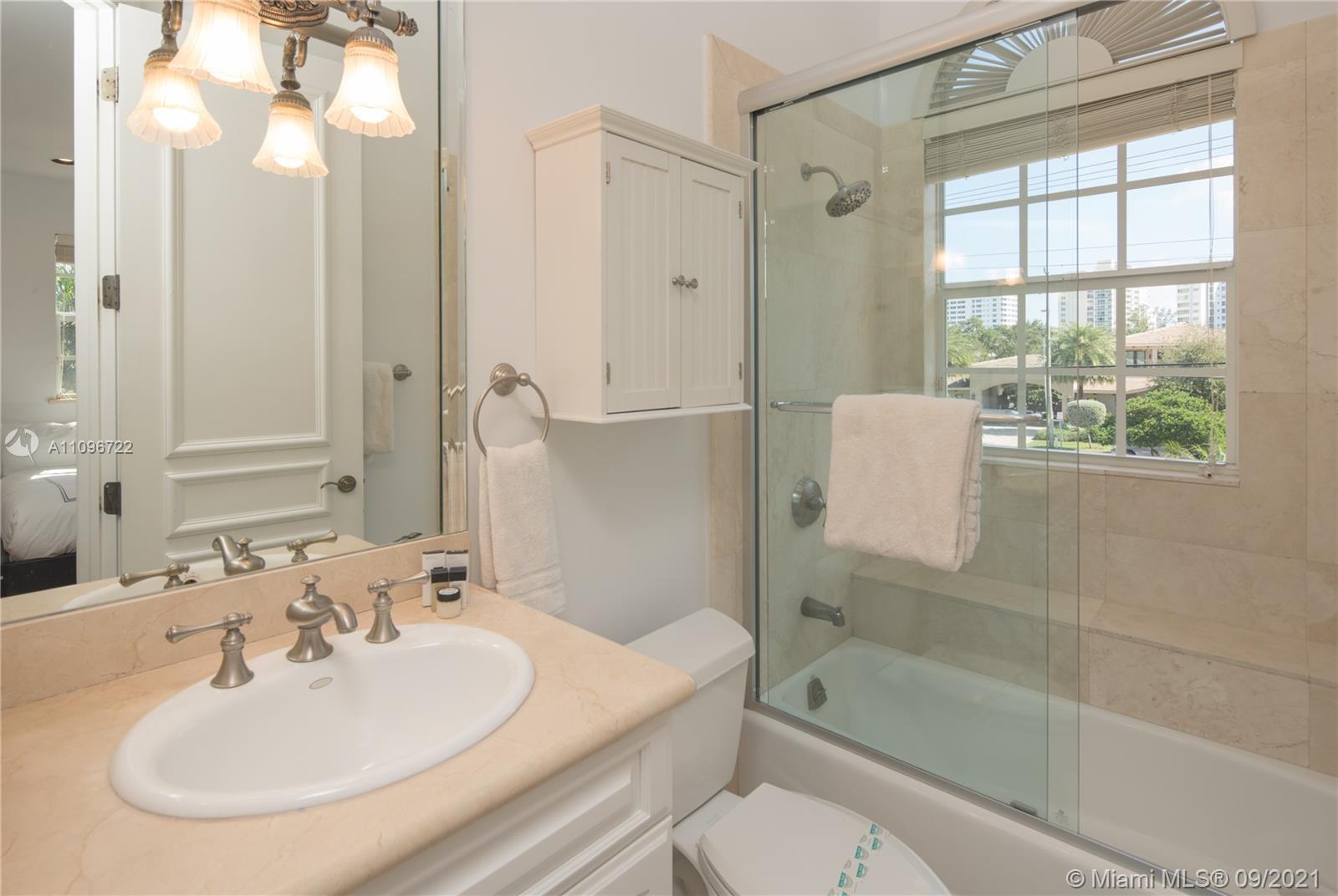 4900 Pine Tree Drive Miami Beach, FL 33140 - Photo 42 of 64 a bathroom with a sink toilet and shower