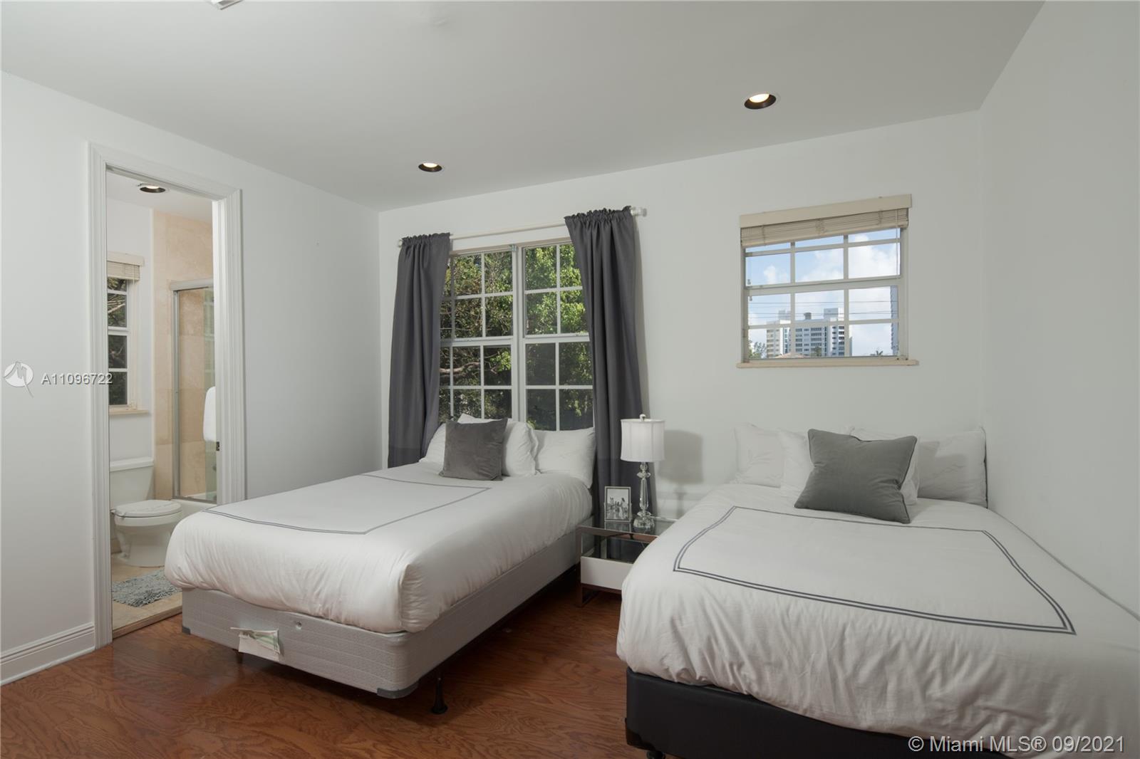 4900 Pine Tree Drive Miami Beach, FL 33140 - Photo 46 of 64 a bedroom with a bed and window