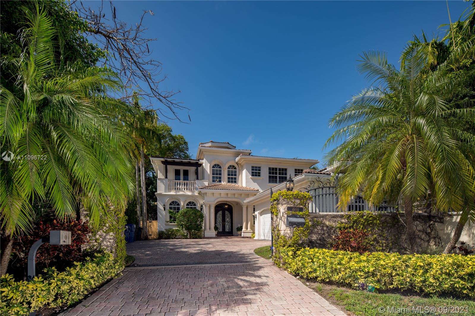 4900 Pine Tree Drive Miami Beach, FL 33140 - Photo 6 of 64 a front view of a house with a garden