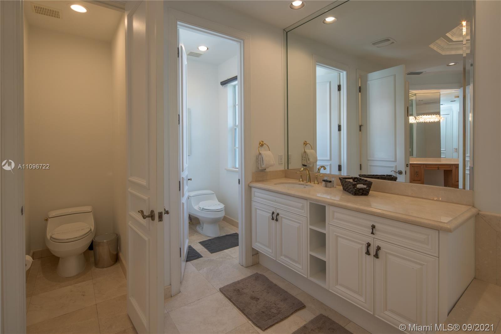 4900 Pine Tree Drive Miami Beach, FL 33140 - Photo 54 of 64 a bathroom with a double vanity sink toilet and shower
