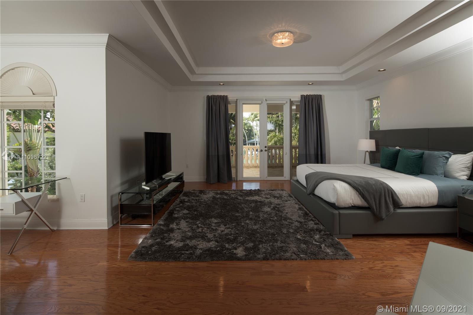 4900 Pine Tree Drive Miami Beach, FL 33140 - Photo 58 of 64 a living room with furniture and a flat screen tv