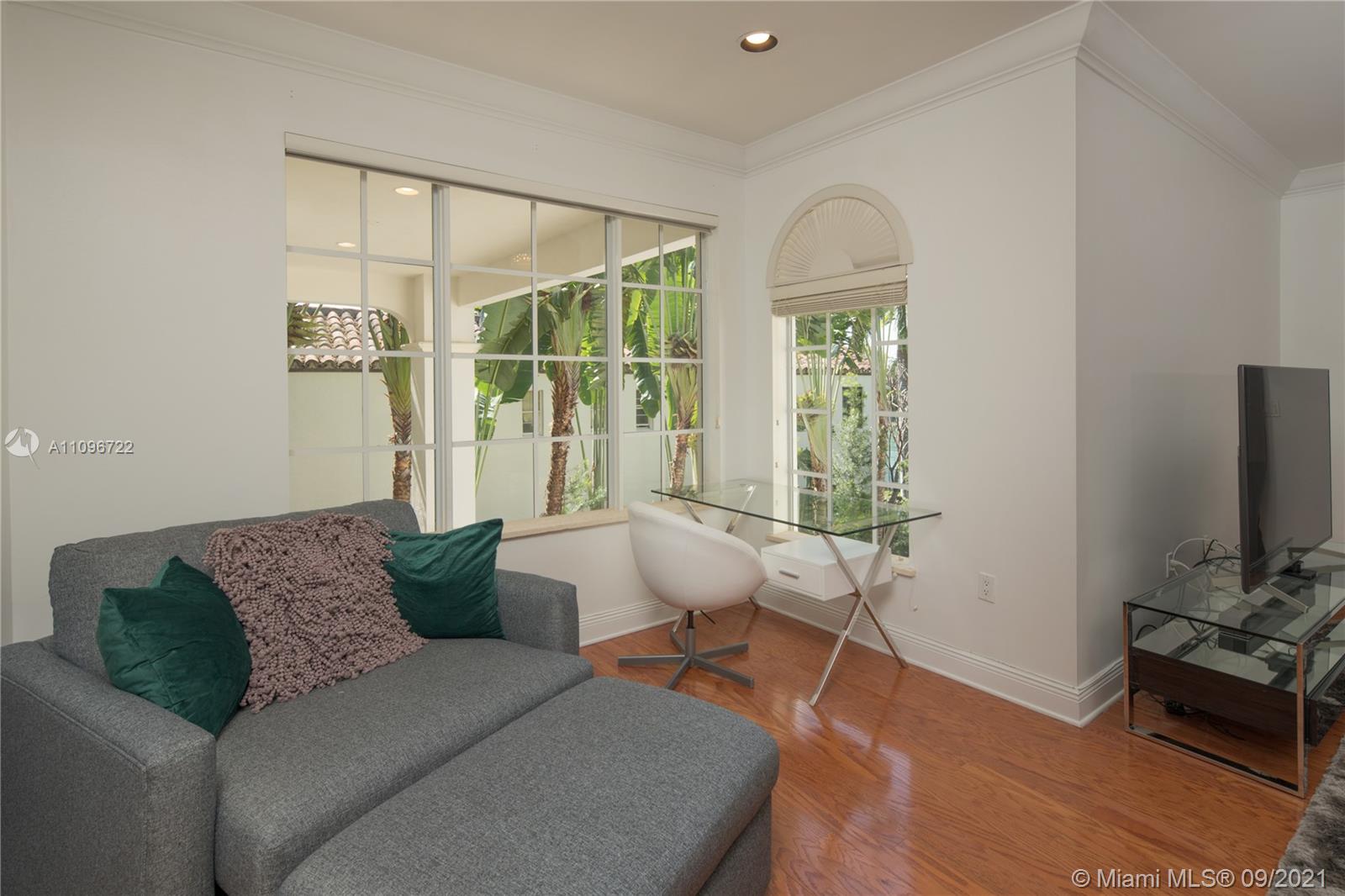 4900 Pine Tree Drive Miami Beach, FL 33140 - Photo 59 of 64 a living room with furniture and a flat screen tv