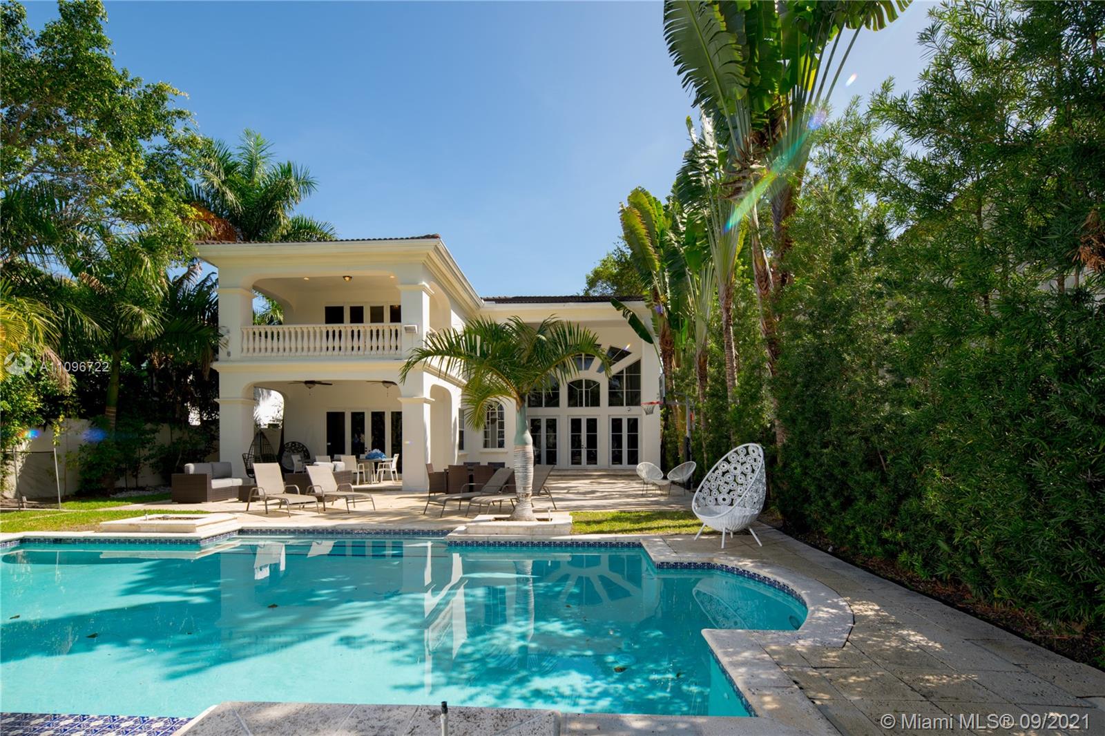 4900 Pine Tree Drive Miami Beach, FL 33140 - Photo 7 of 64 a swimming pool with outdoor seating and yard