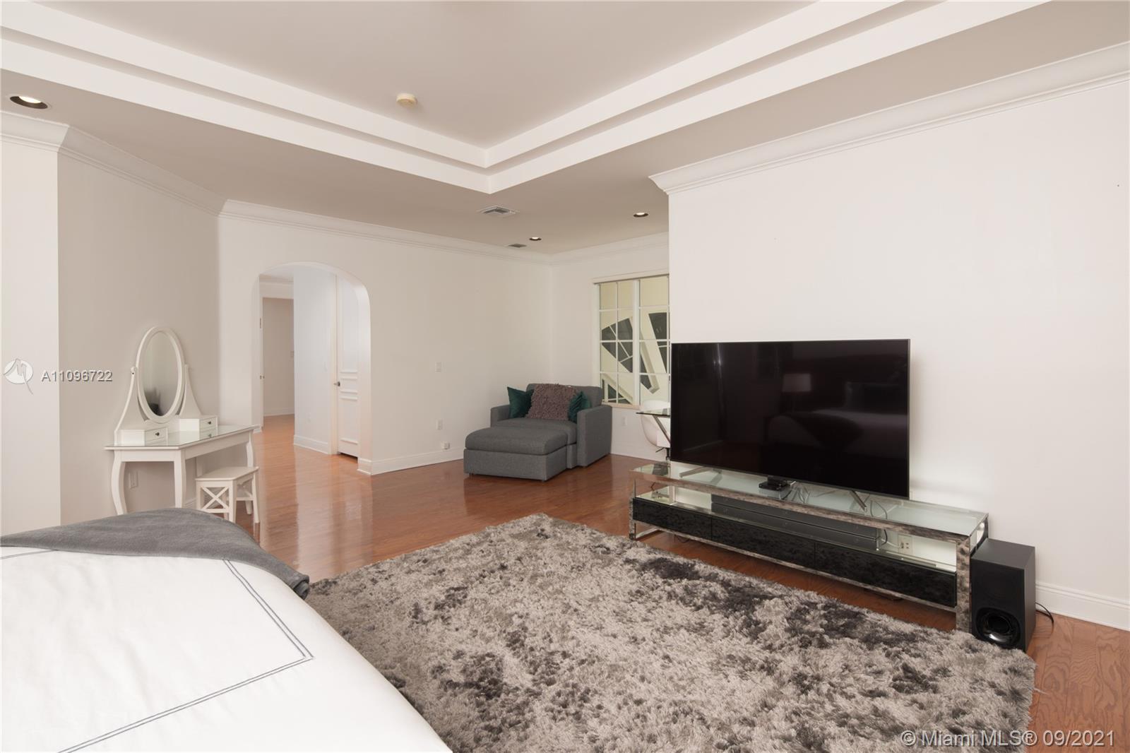 4900 Pine Tree Drive Miami Beach, FL 33140 - Photo 62 of 64 a living room with furniture and a flat screen tv