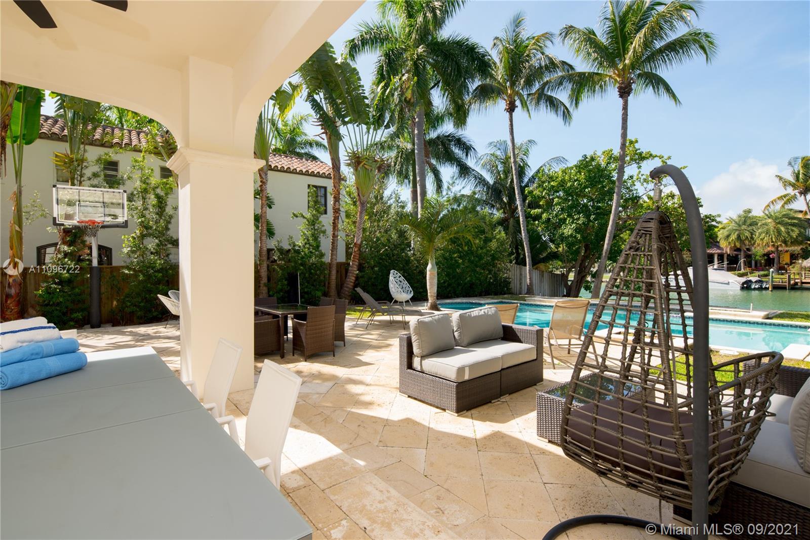 4900 Pine Tree Drive Miami Beach, FL 33140 - Photo 8 of 64 a view of a patio with couches and a fire pit