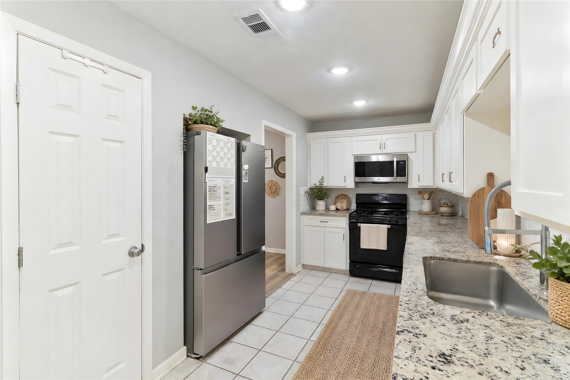 117 Cannon Street Clute, TX 77531 - Photo 9 of 24 Bright white cabinetry, updated countertops and a gas stove give the kitchen a clean, functional look.