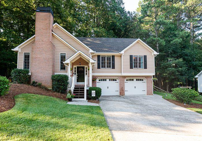 913 Fernwood Road Woodstock, GA 30189 - Photo 1 of 1 a front view of a house with a yard
