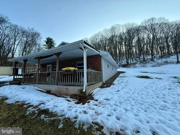a view of a house with a yard covered in snow