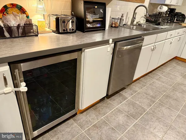 a kitchen with a sink a stove and cabinets
