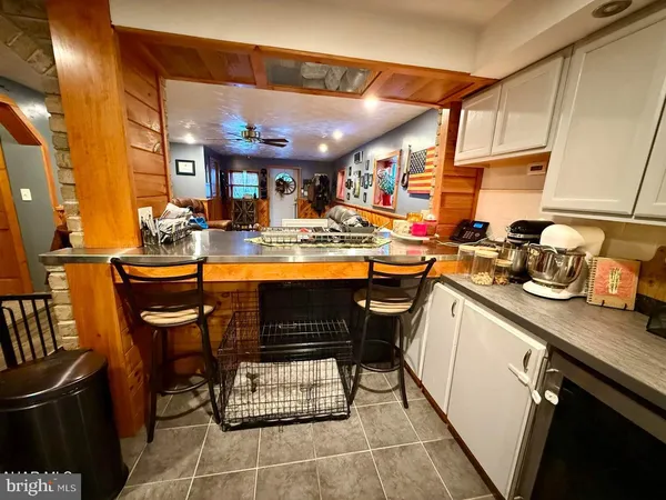 a kitchen with a sink a stove and chairs