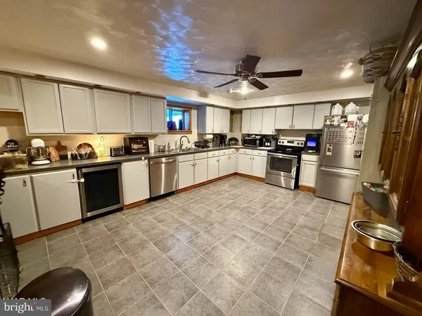 a kitchen with a sink appliances and cabinets