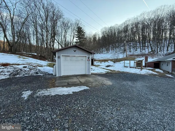 a view of a house with a yard covered in snow