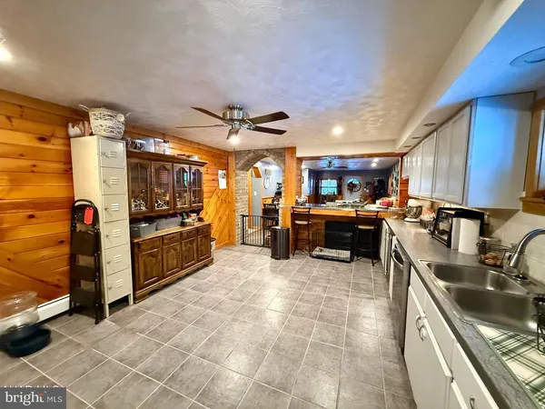 a kitchen with stainless steel appliances granite countertop a sink and cabinets