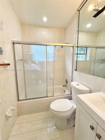 a bathroom with a toilet sink and shower