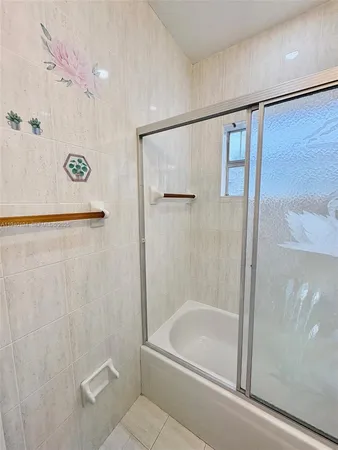 a bathroom with a shower and a bath tub