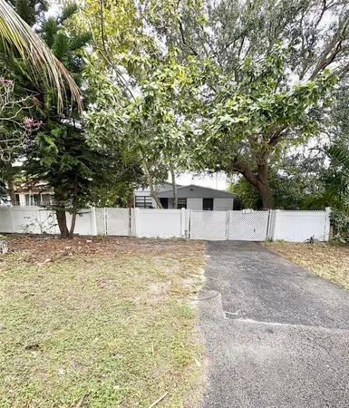 a view of a yard with large trees