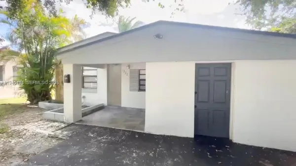 a front view of a house with a yard and a garage
