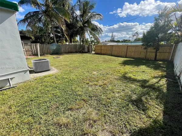 a view of a swimming pool with a yard
