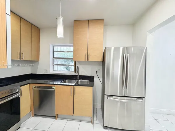 a kitchen with granite countertop stainless steel appliances and white cabinets