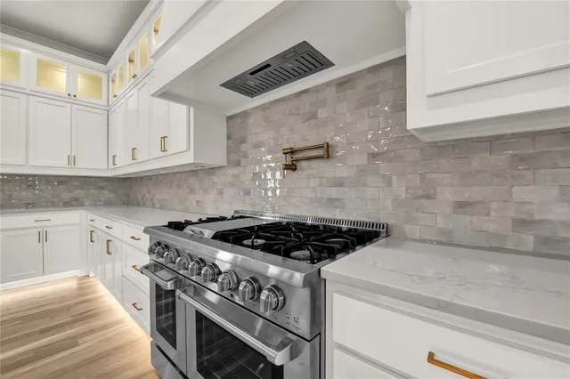 a stove top oven sitting inside of a kitchen
