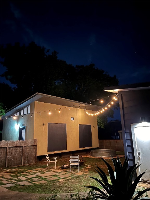 4619 Jinx Avenue, Unit A Austin, TX 78745 - Photo 13 of 15 Back of house at night featuring a patio