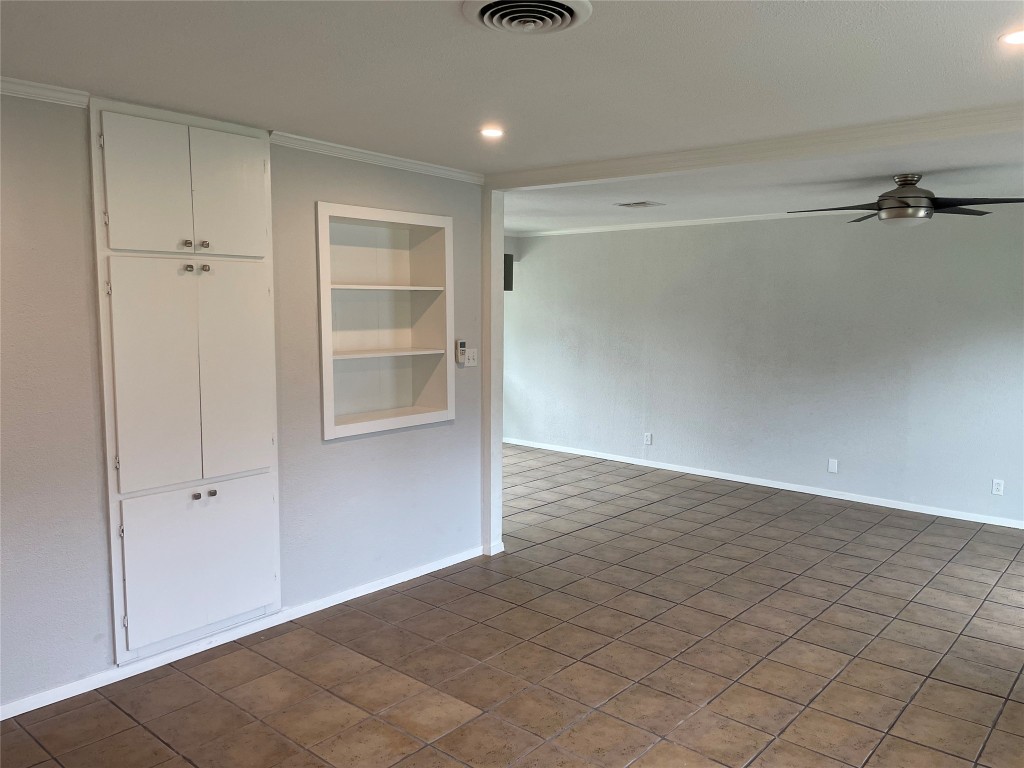 4619 Jinx Avenue, Unit A Austin, TX 78745 - Photo 3 of 15 Empty room featuring built in features, ceiling fan, ornamental molding, and recessed lighting