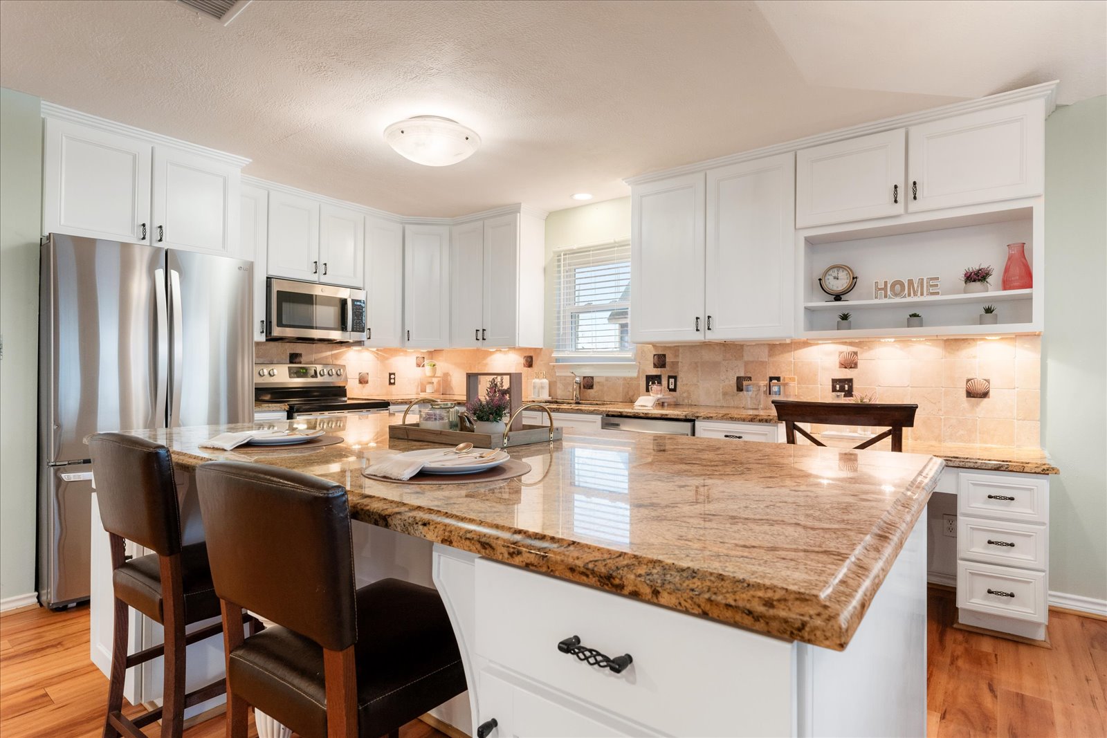 24043 Termini-San Luis Pass Road Galveston, TX 77554 - Photo 11 of 26 a kitchen with stainless steel appliances granite countertop a sink stove and refrigerator
