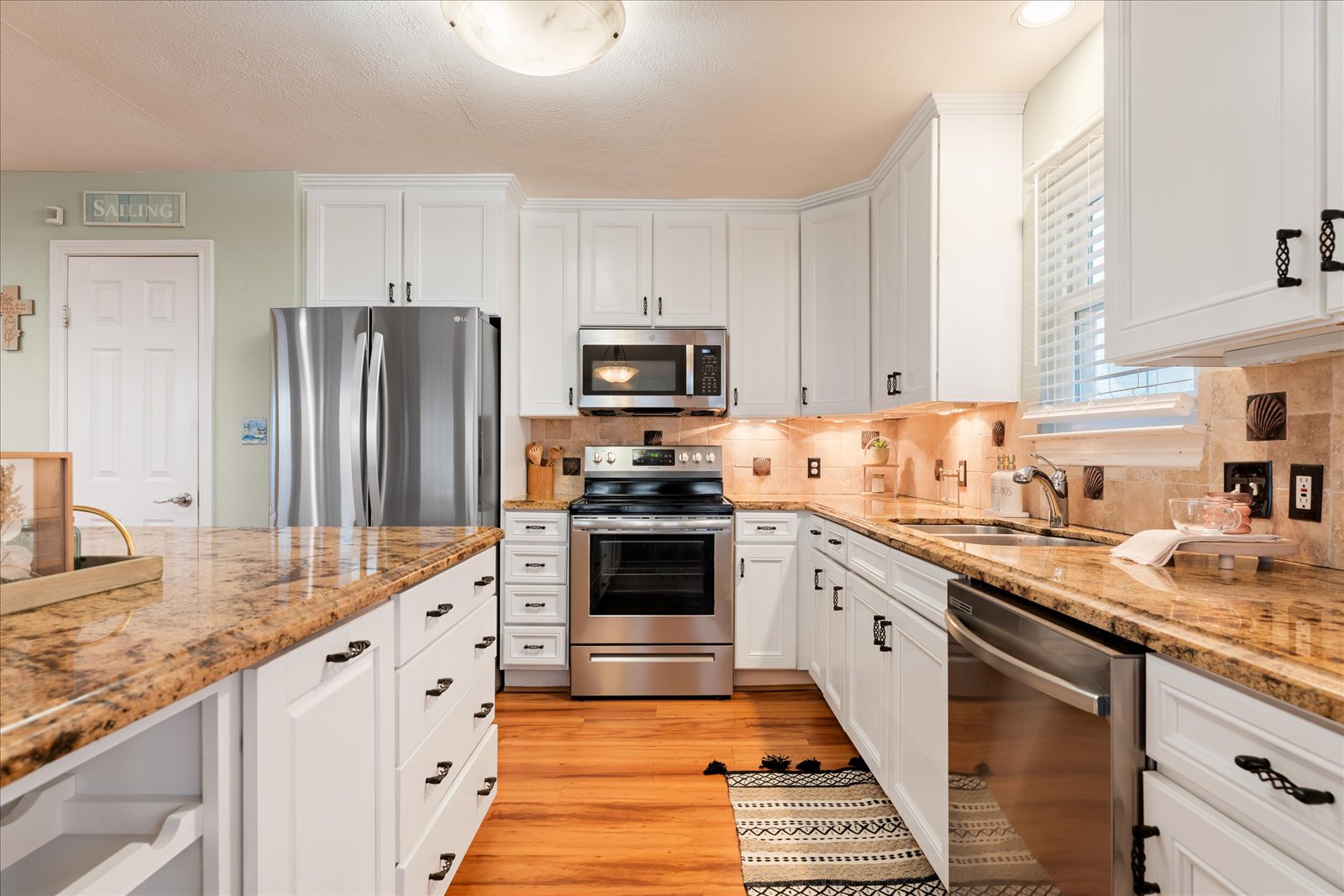 24043 Termini-San Luis Pass Road Galveston, TX 77554 - Photo 13 of 26 a kitchen with granite countertop stainless steel appliances and white cabinets