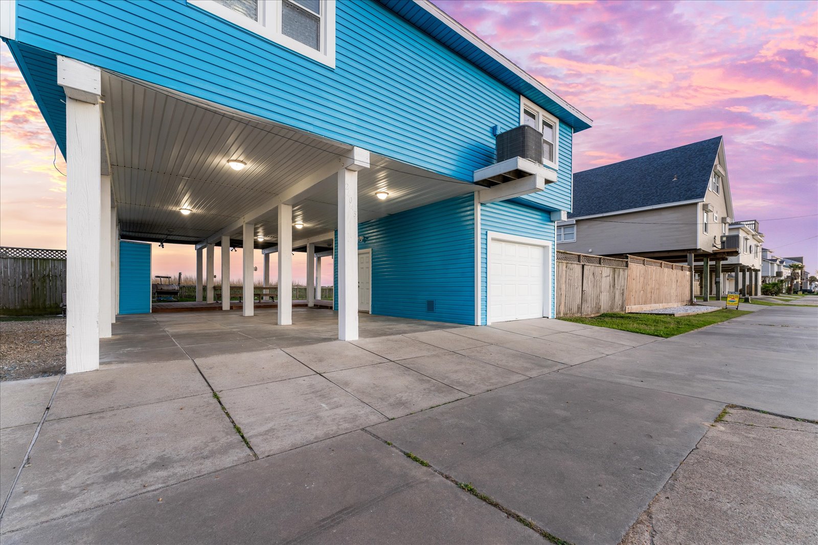 24043 Termini-San Luis Pass Road Galveston, TX 77554 - Photo 24 of 26 a view of a house with a backyard and garage