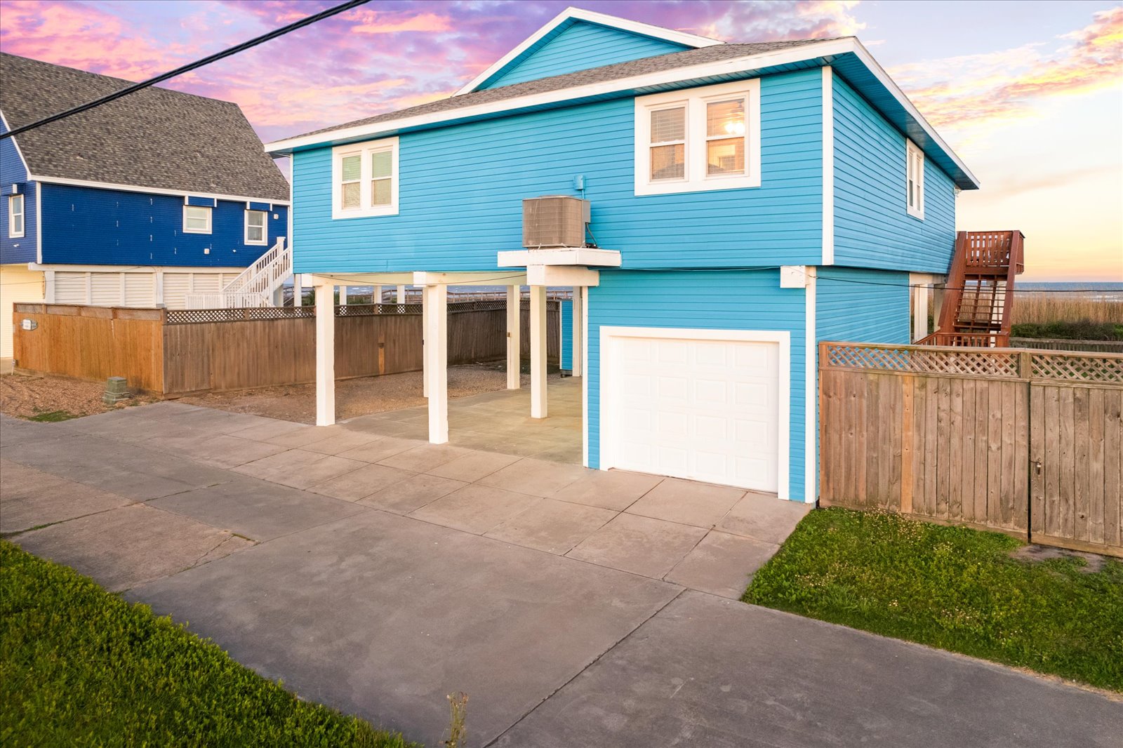 24043 Termini-San Luis Pass Road Galveston, TX 77554 - Photo 25 of 26 a backyard of a house with wooden fence and a porch