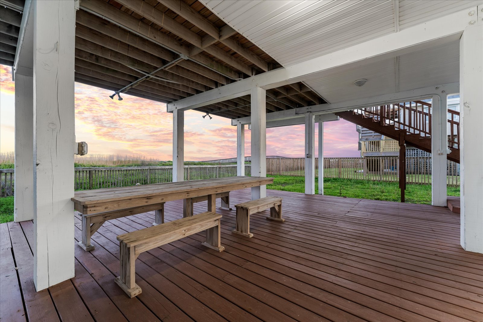 24043 Termini-San Luis Pass Road Galveston, TX 77554 - Photo 26 of 26 a view of a roof deck with wooden floor and fence with a floor to ceiling window