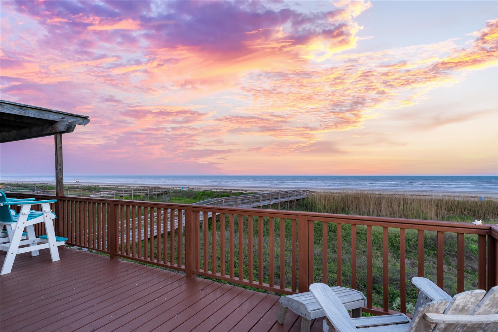 24043 Termini-San Luis Pass Road Galveston, TX 77554 - Photo 3 of 26 a view of a balcony with chairs and wooden floor