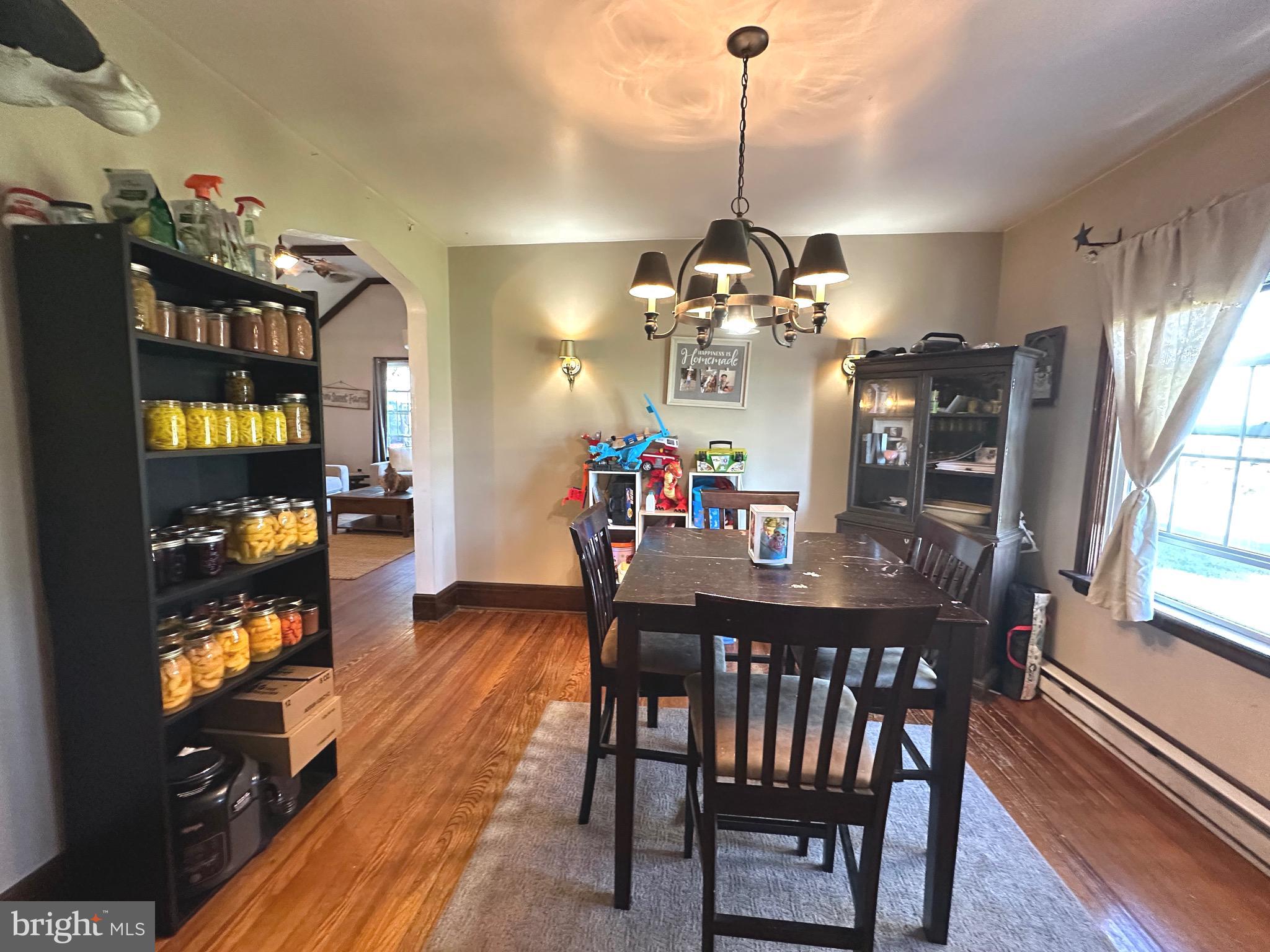 18452 Path Valley Road Dry Run, PA 17220 - Photo 14 of 45 a view of a dining room and livingroom with furniture wooden floor a chandelier