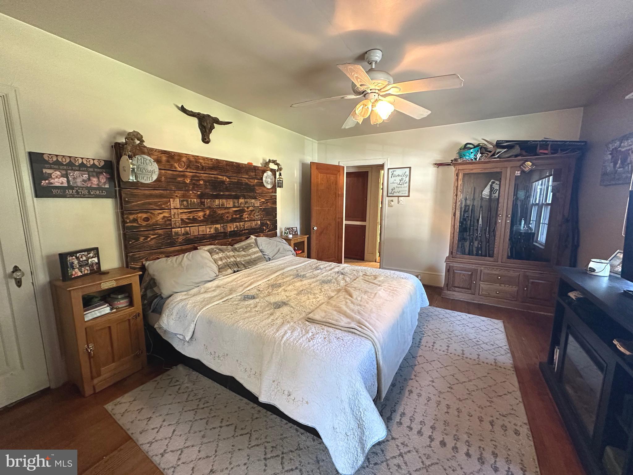 18452 Path Valley Road Dry Run, PA 17220 - Photo 16 of 45 a bedroom with a large bed and a chandelier