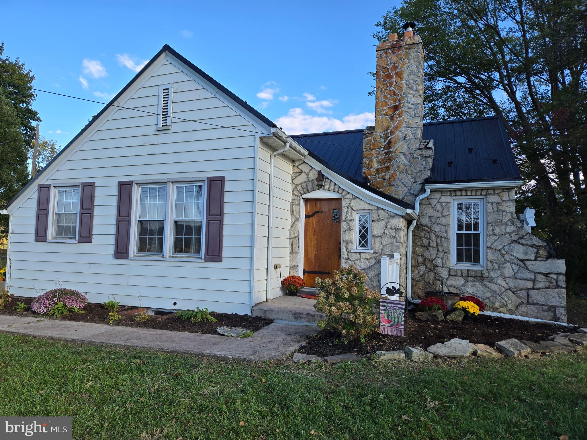 18452 Path Valley Road Dry Run, PA 17220 - Photo 3 of 45 a front view of house with yard and outdoor seating