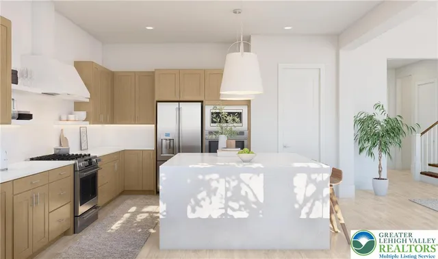 a kitchen with stainless steel appliances granite countertop a refrigerator a stove and a sink