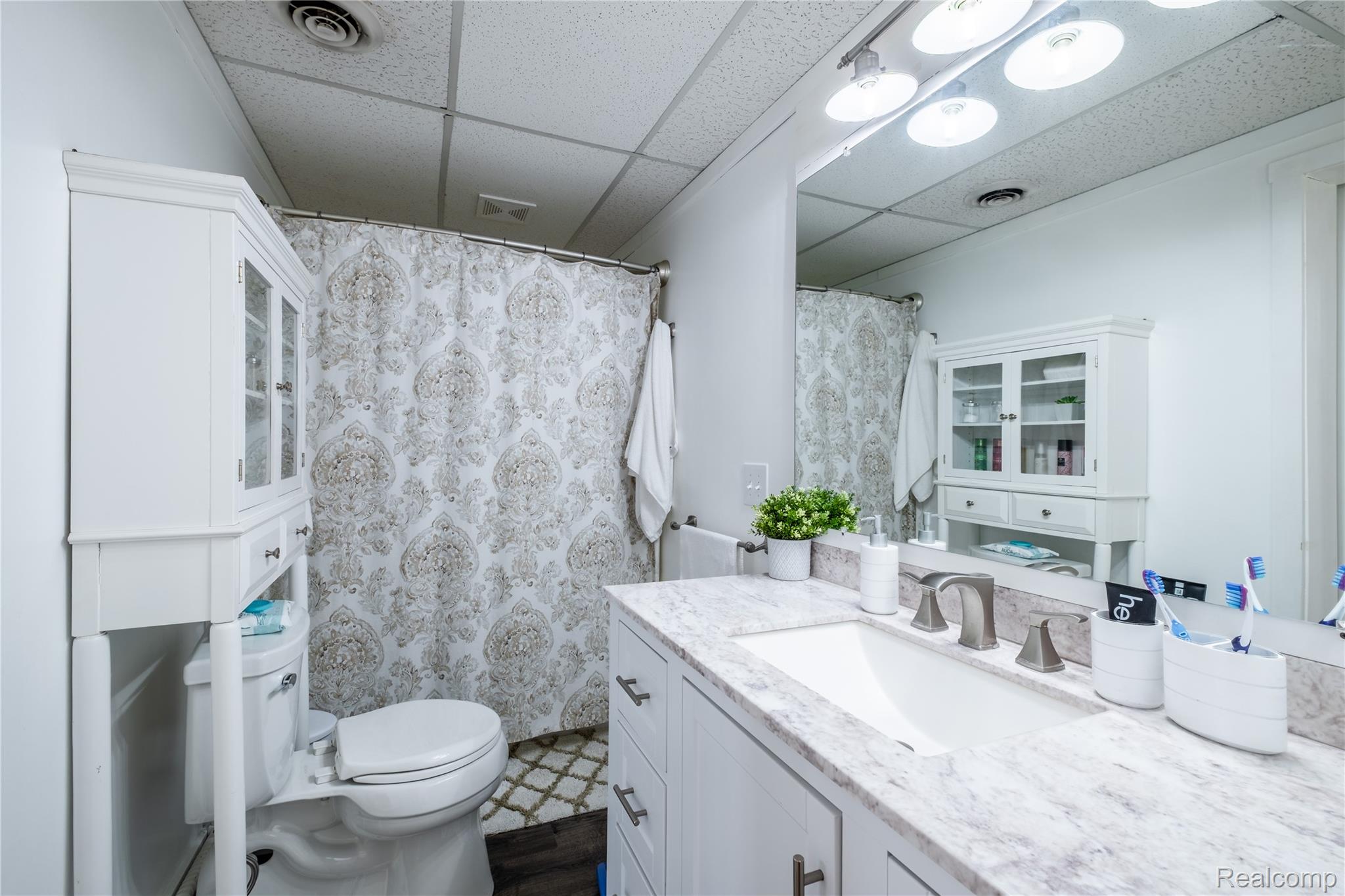 12164 Miller Road Lennon, MI 48449 - Photo 27 of 35 Full bathroom featuring a paneled ceiling, vanity, and a shower with shower curtain