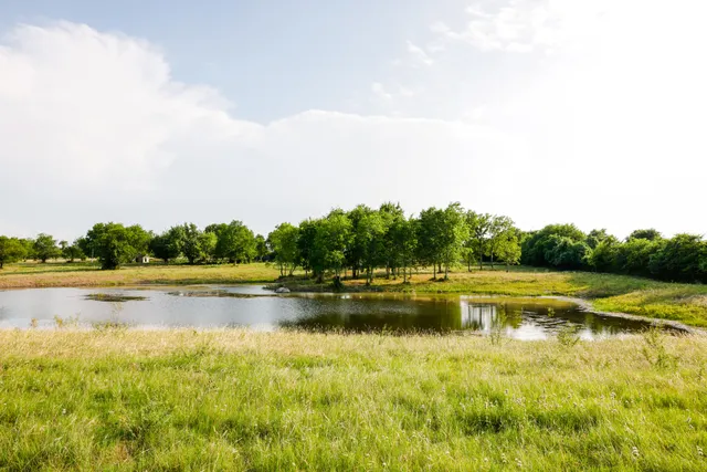 a view of a lake with houses in the back