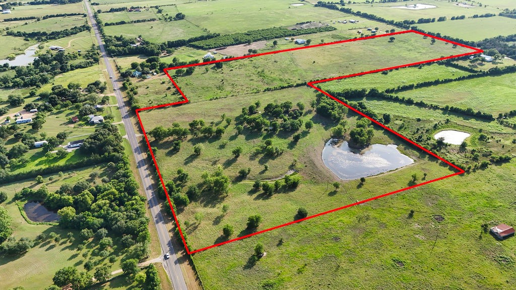 1504 Highway 237 Burton, TX 77835 - Photo 3 of 15 an aerial view of a tennis ground and a large tree